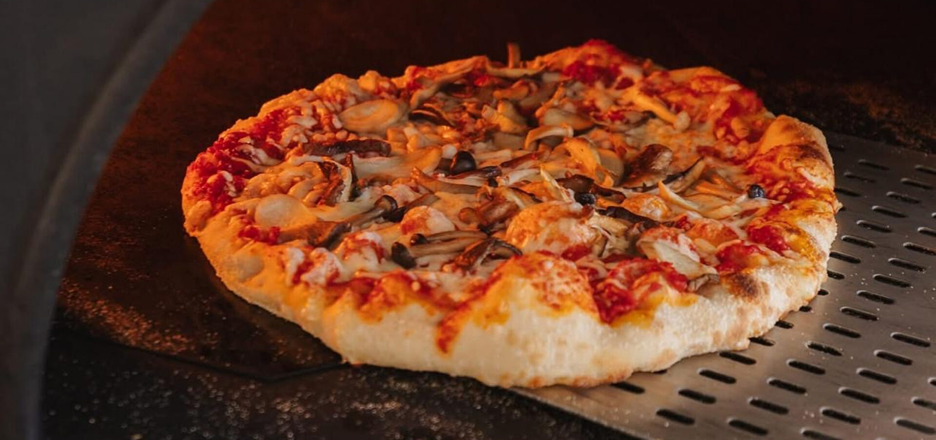 Pizza baking in a wood-fired oven