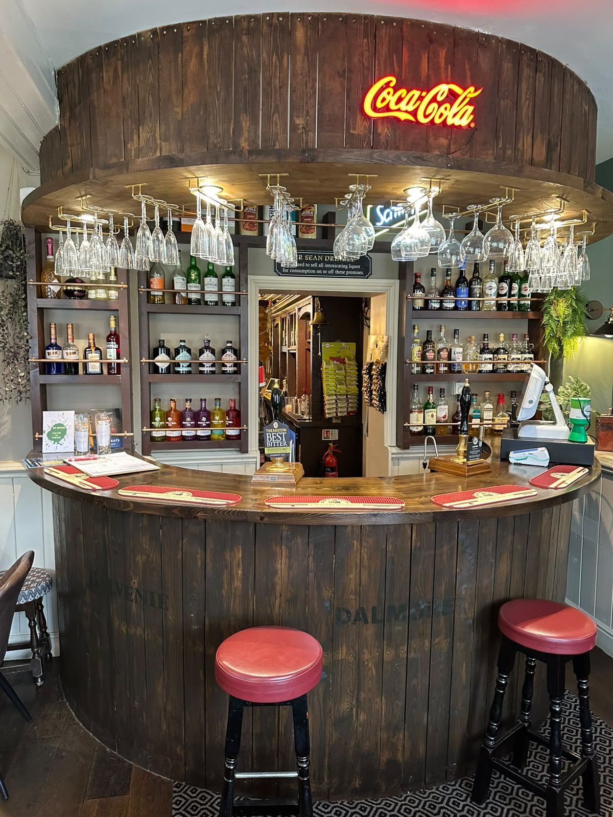 Wooden pub bar with Coca-Cola neon sign